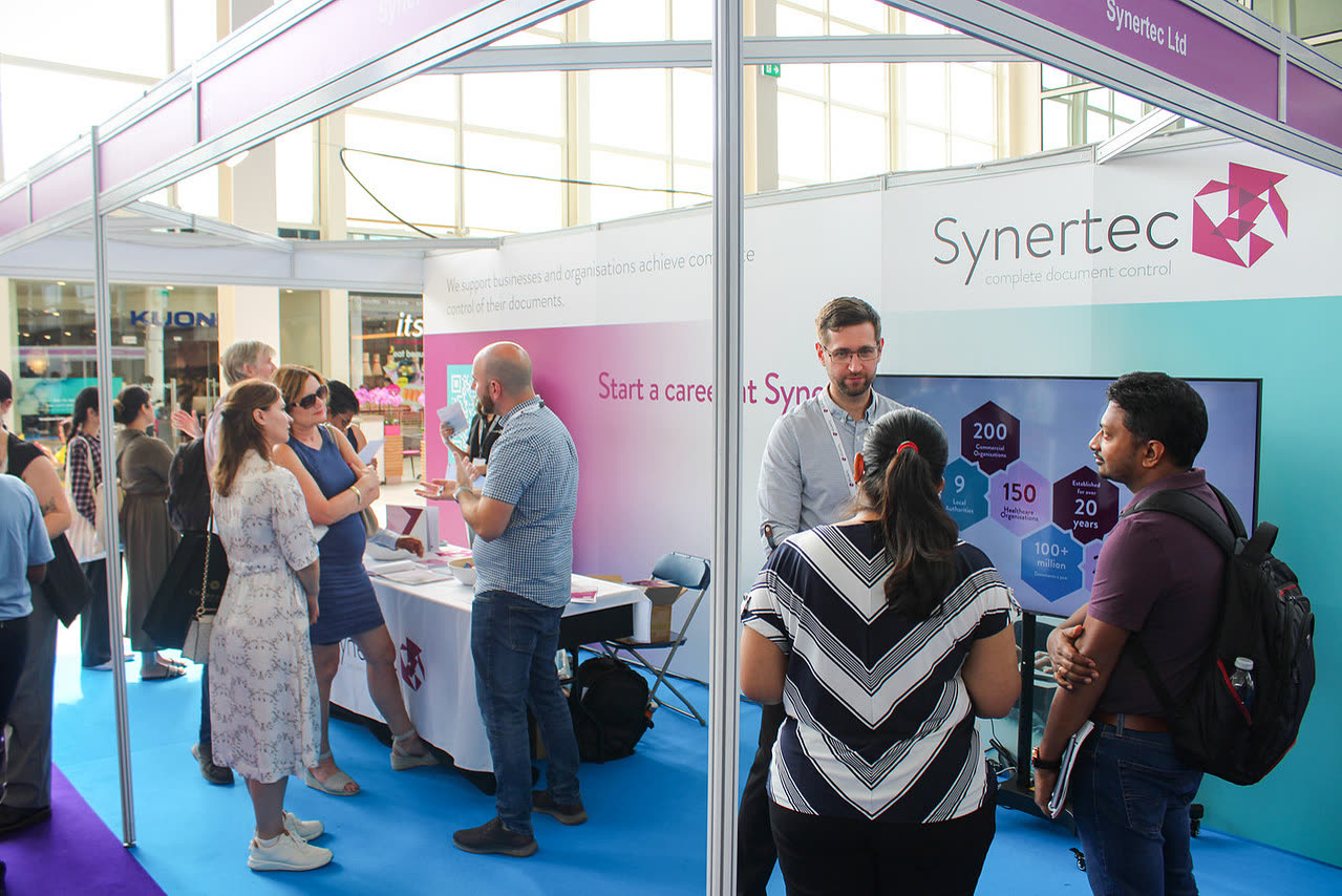An employer meeting candidates at their stand at the MK Job Show