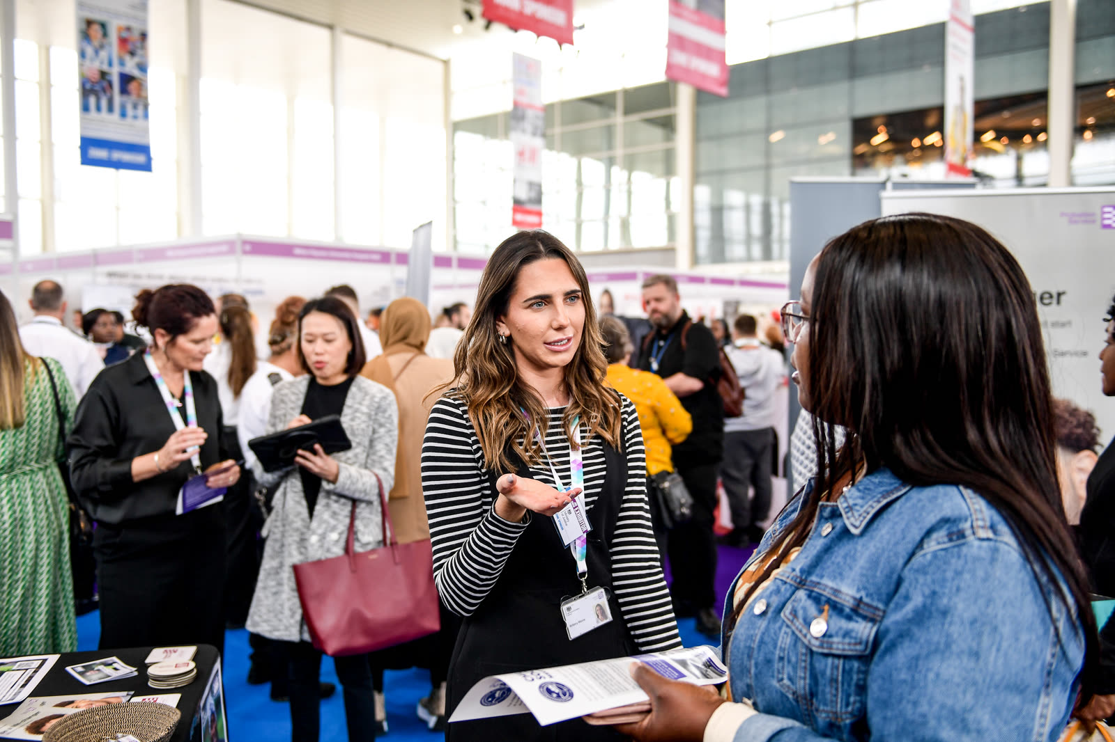 An employer and candidate in conversation at a recruitment stand at the MK Job Show